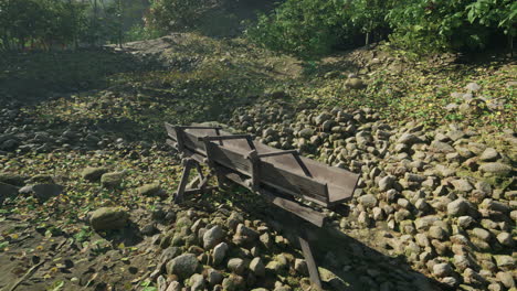 old wooden trough in a stone-covered forest