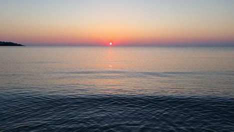 calm rirrpled water surface of the sea at sunrise