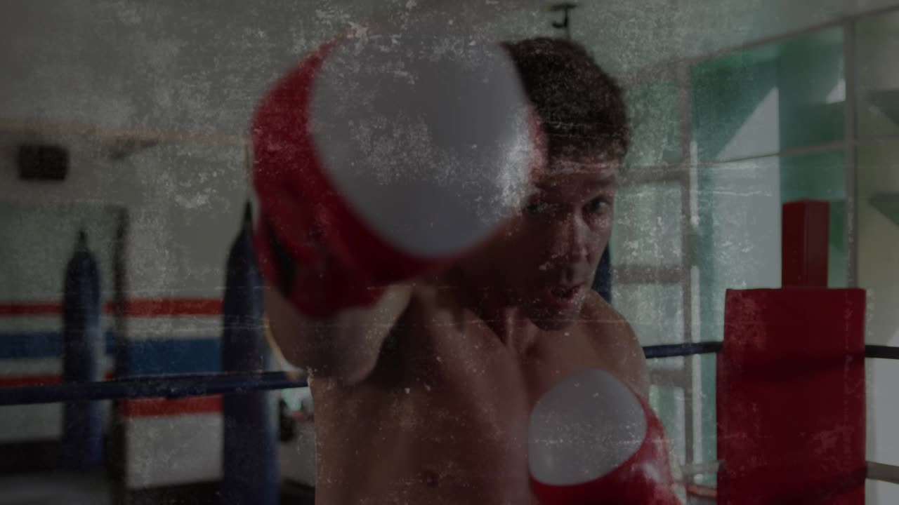 Male boxer shifting weight and throwing punches with gloves for training, grime overlay animating