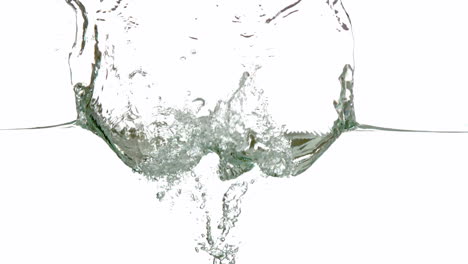 lime plunging into water on white background