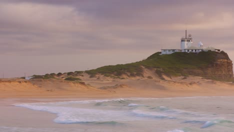 Nobby's-Beach-Lighthouse-at-Sunrise,-NSW,-Australia