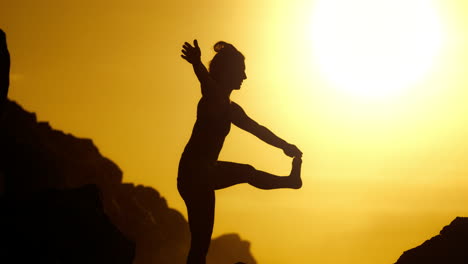 sunrise yoga pose on rocks
