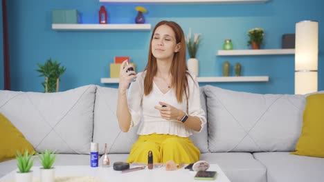 mujer joven rociando perfume, buen olor.