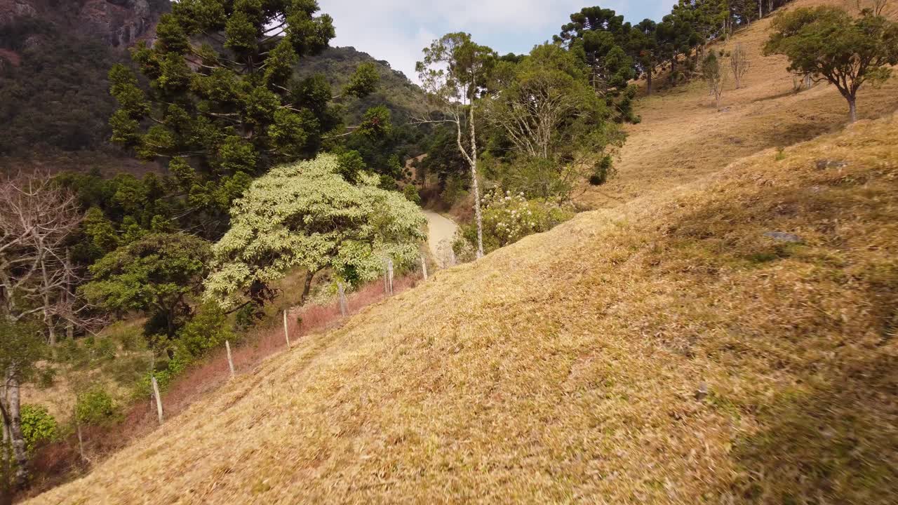 교통량이 많은 자갈길을 향해 굴곡진 언덕을 활공하는 시골 쪽 영상