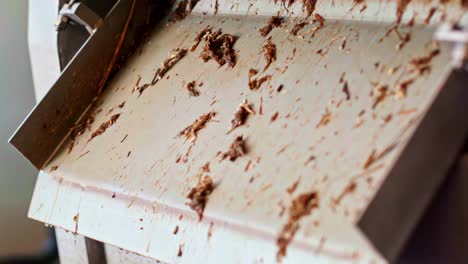 close-up of a dirty tray or surface with scattered debris and organic waste in an unsanitary setting
