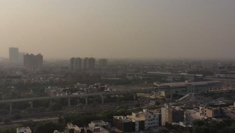 Aerial-Drone-Footage-Of-urban-City-buildings,-residential-houses-and-pollution-in-New-Delhi,-India-4k-UHD