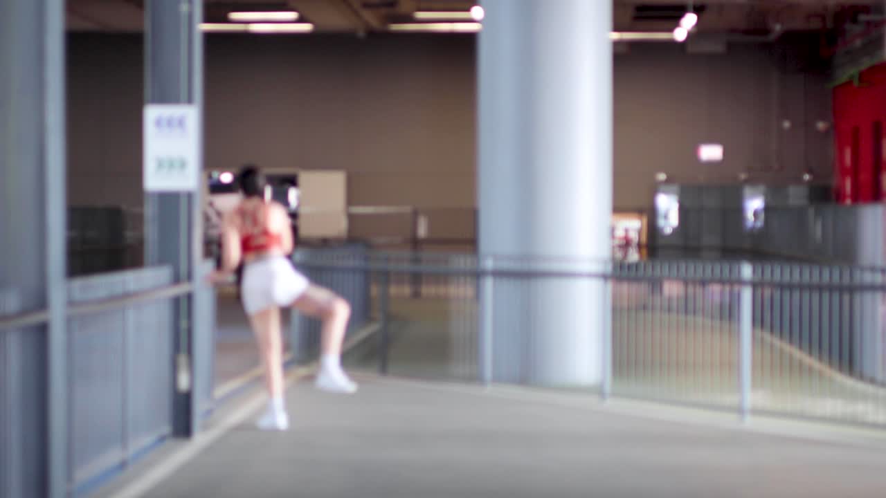 Individual performing dynamic stretches in a spacious area