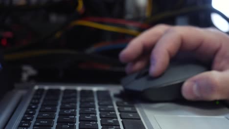 person working on a laptop in a data center