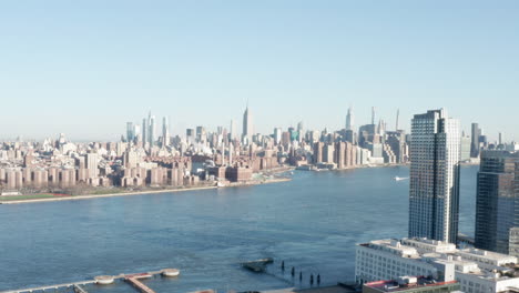 nyc skyline with empire state building from brooklyn side camera going down on a sunny day neutral cc