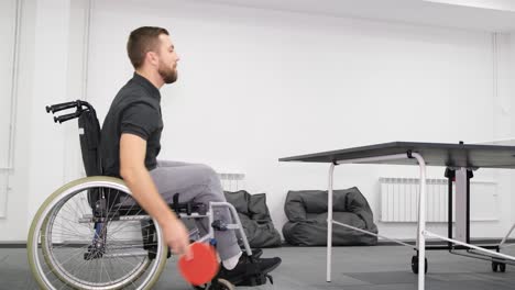A Handsome Young Bearded Man in a Wheelchair is Playing Ping Pong a Handsome Young Bearded Man in a Wheelchair is Playing Ping Pong Sports as a Hobby and Health Benefits