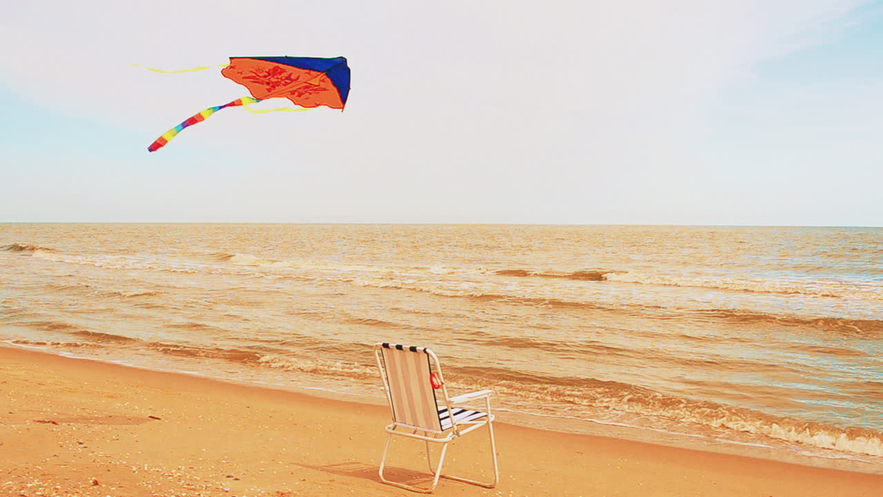 Chaise lounge on the beach, the sea and a kite. Summer Time in Beach Sea Shore