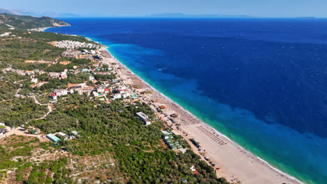 un avión no tripulado gira en círculo sobre una playa en la riviera de albania, en el soleado dharmi, albania.