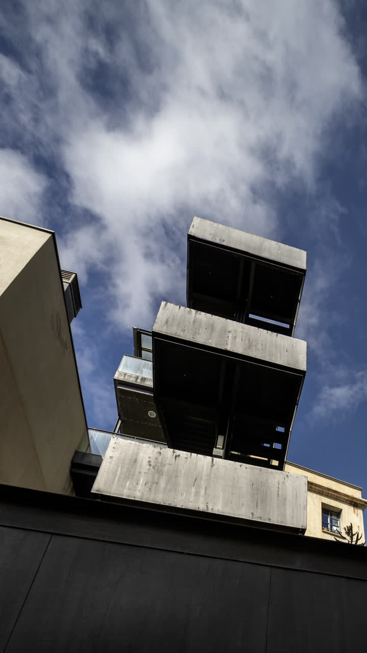 Old factory chimney and apartment buildings in barcelona in vertical