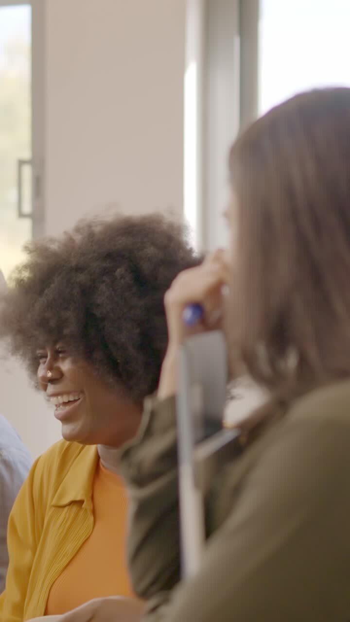 Happy coworking collegues laughing in a meeting