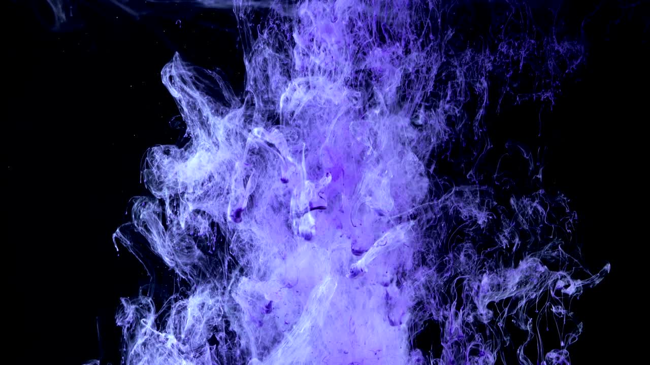 Abstract colorful purple ink in water on black background. Dropping ink in water,