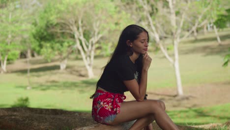 on the island of trinidad, a young latin girl in shorts spends a sunny day having fun at the park.