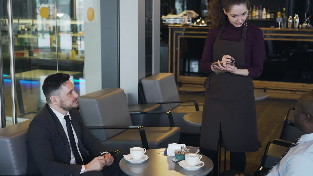 Cafe Scene: Waitress Taking Order from Customers