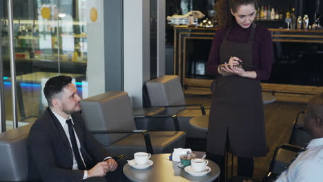 cafe scene: waitress taking order from customers