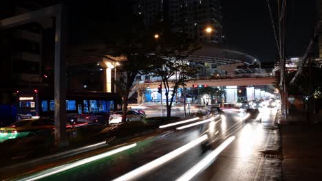 A-nighttime-time-lapse-shot-of-cars-whizzing-by-the-camera-at-high-speed-in-the-streets-of-Bangkok,-Thailand