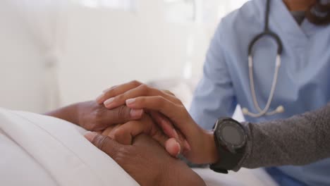 mixed race woman being visited at home by a nurse. social distancing and self isolation in quarantin