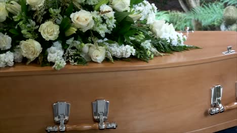 closeup shot of a funeral casket in a hearse or chapel or burial at cemetery