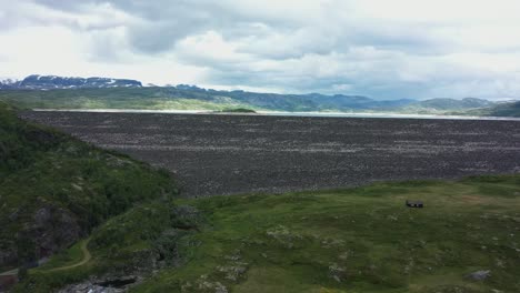 hydroelectric water reservoir - slowly rotating and ascending aerial revealing water level inside dam as electricity prices rising - norway