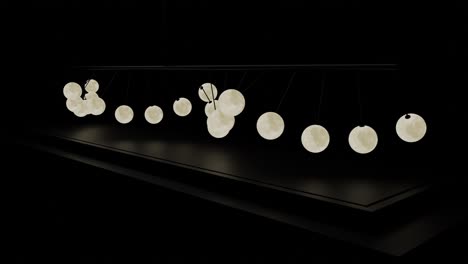 newton's cradle with moon balls