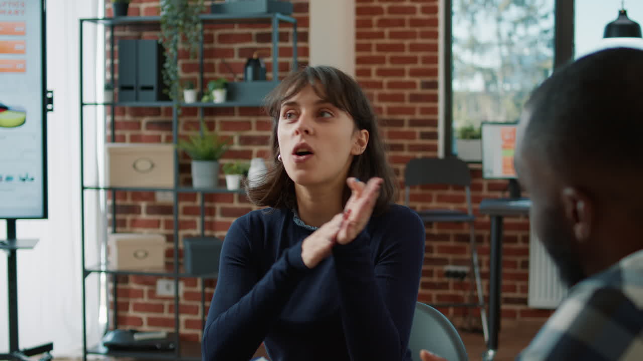 Young woman greeting HR manager at job application meeting