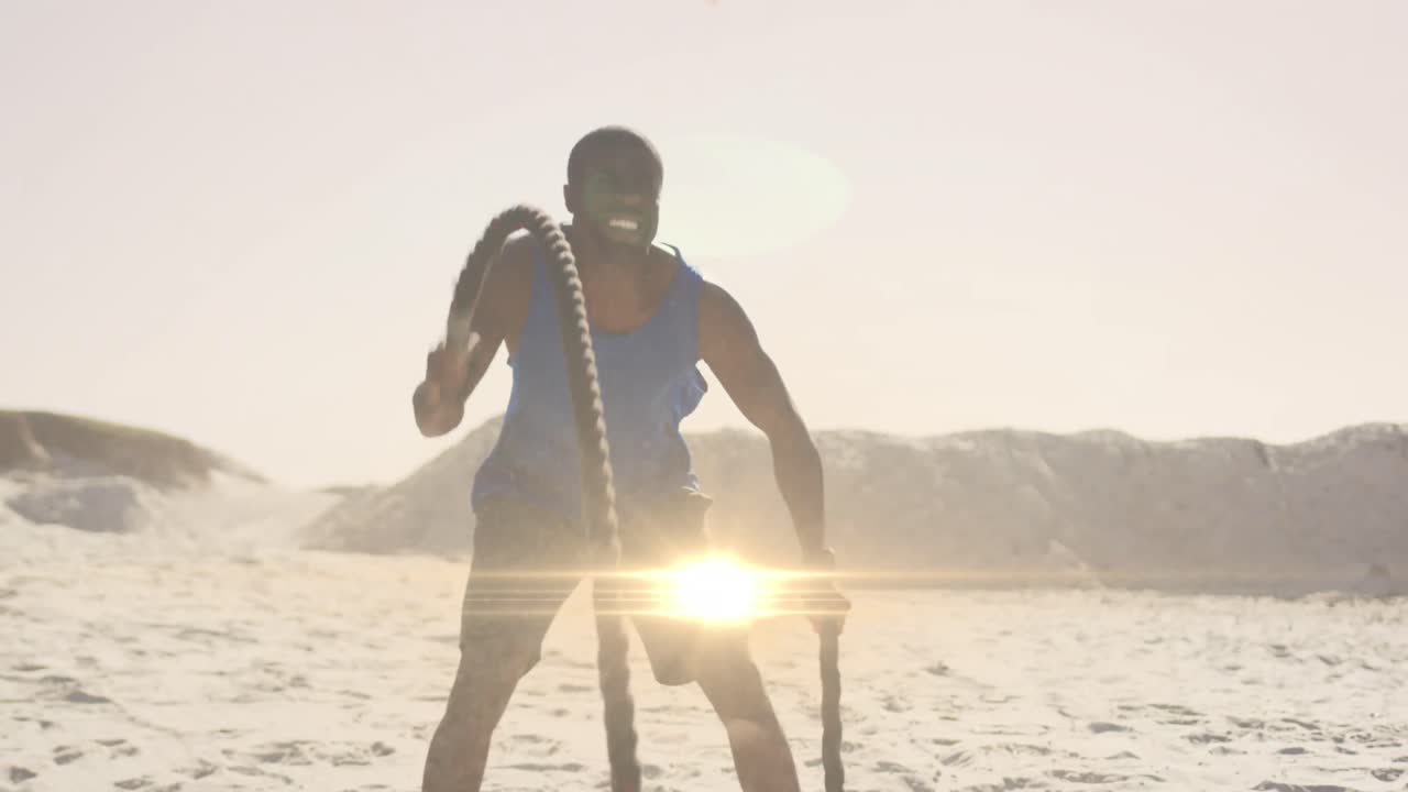 Animation of glowing lights over an exercising african american man