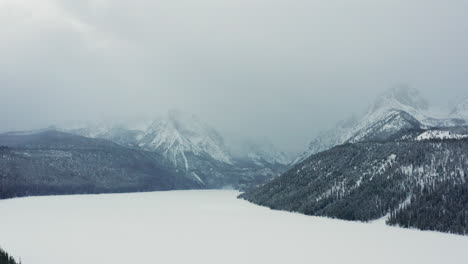 aerial over frozen redfish lake with sawtooth mountains looming in background