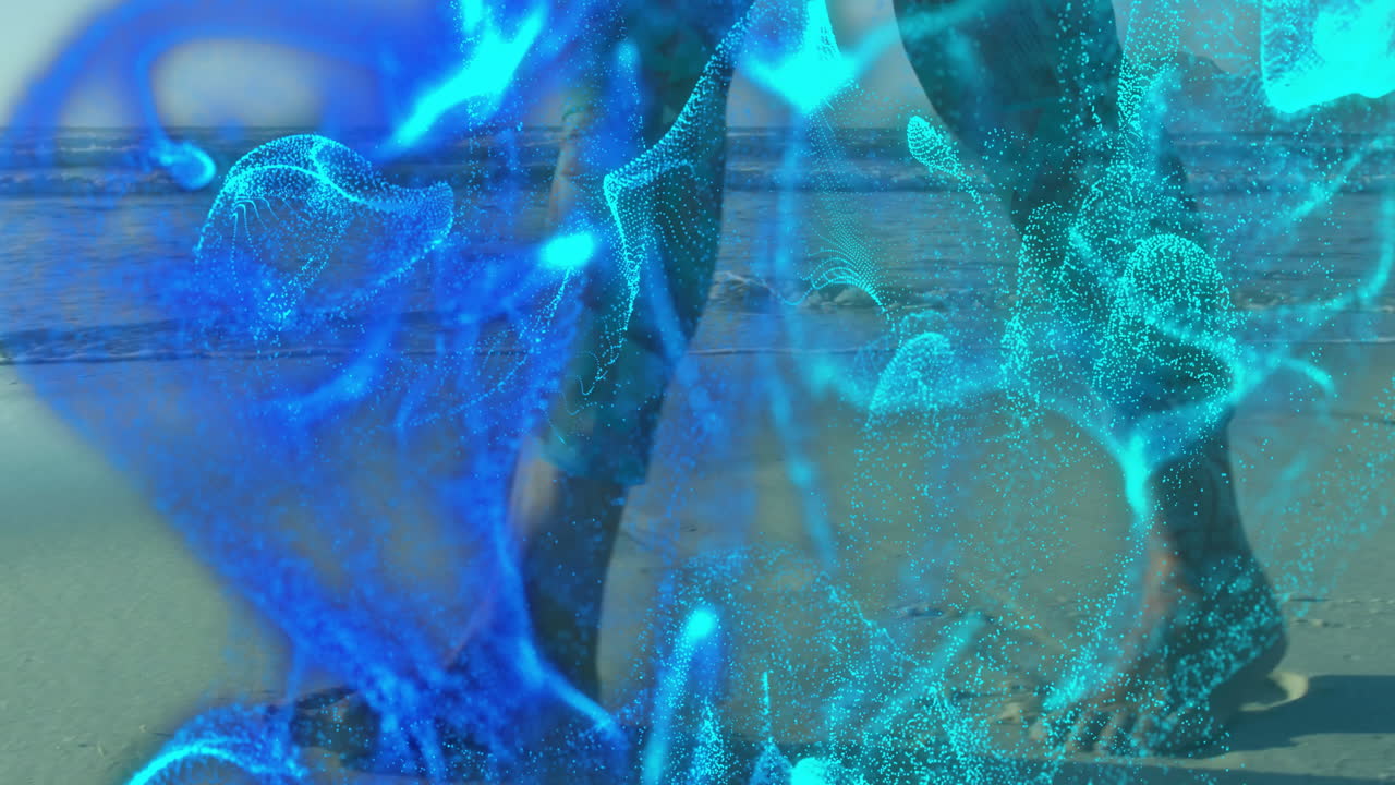 Senior woman walking along shoreline while blue particles swirling as holographic tech overlay