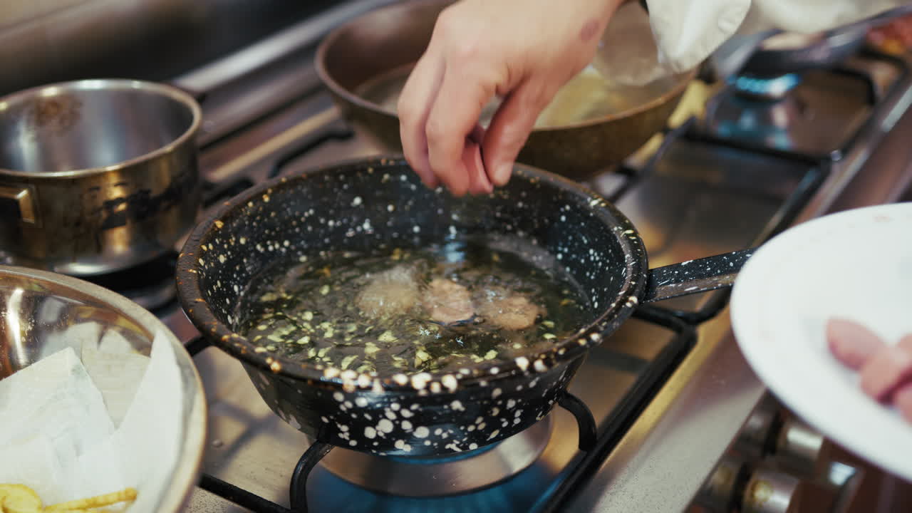 Chef Tests To Check If Boiling Oil Is At Temperature For Frying Turkey Sausage