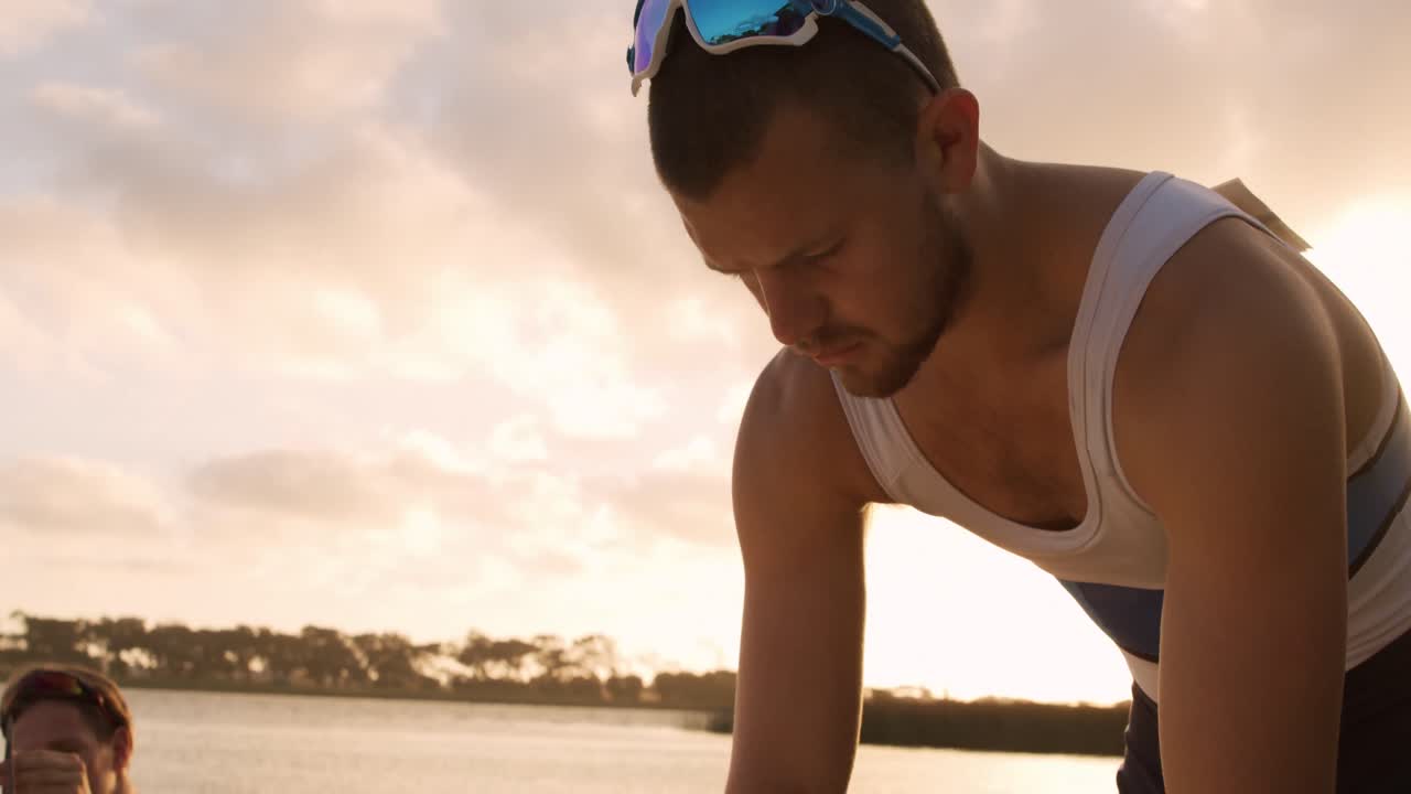 Male rower preparing boat before practice