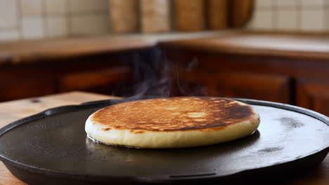cooking a golden brown pancake on a griddle