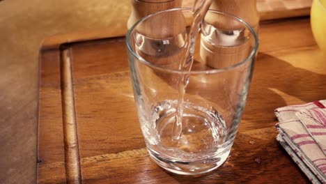 mineral water pouring into a glass, the morning breakfast, slow motion with rotation tracking shot.