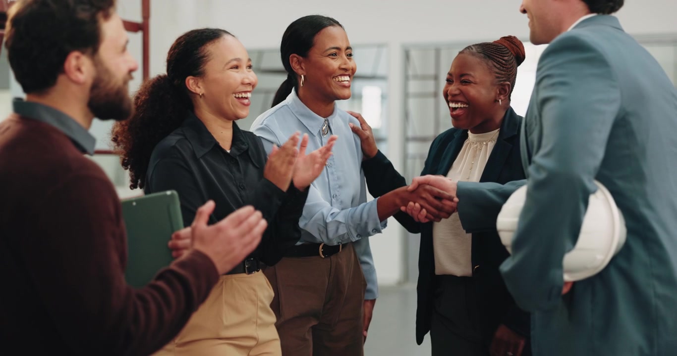 Diverse Business Team Celebrating Success with Handshake and Applause