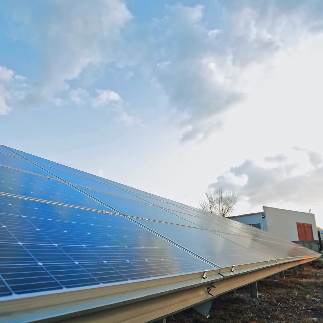 Photovoltaic solar panel under the blue sky. Huge blue sunny battery on the ground in sun reflection. Renewable eco energy. Close-up.