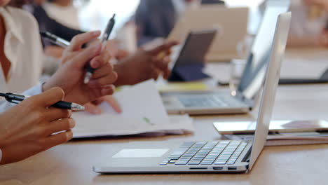 Close-Up-Of-Hands-Using-Laptop-During-Meeting-Around-Table