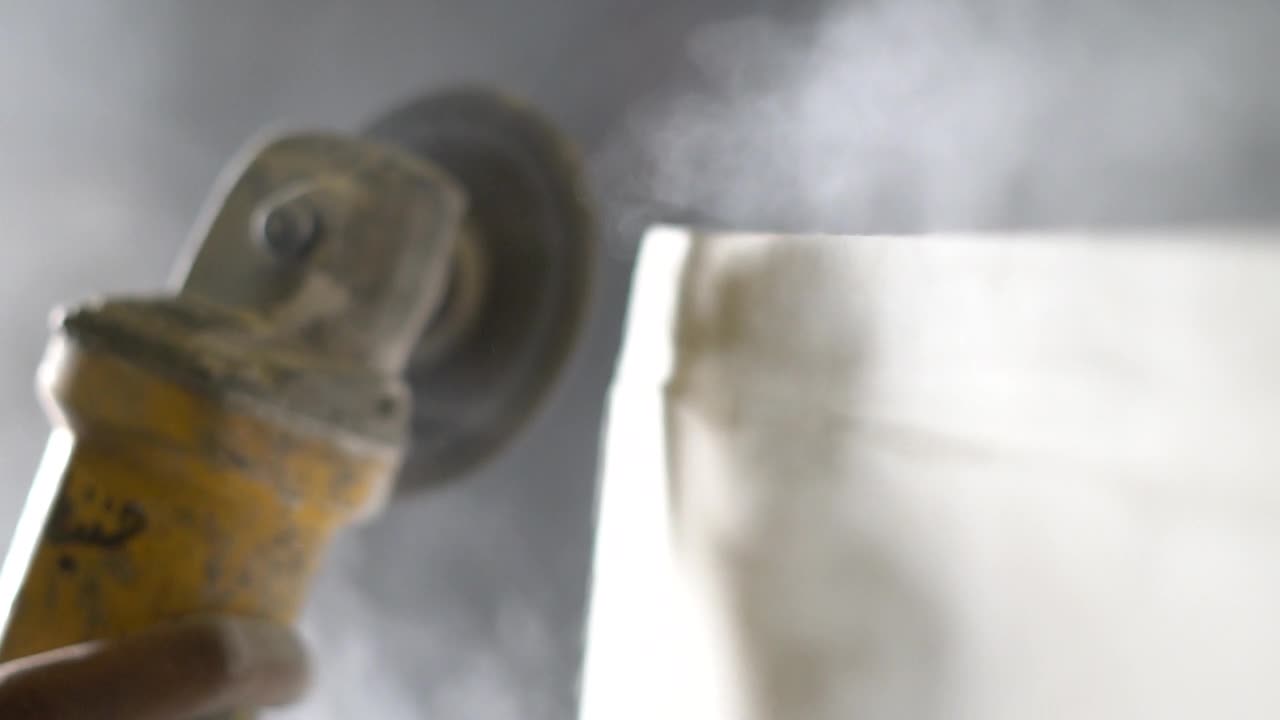 Polishing A Luxury Marble Stone With A Grinding Disc On A Grinder - close up slowmo