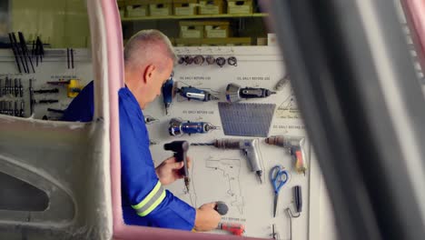 engineer checking tools at aerospace hangar 4k