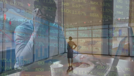 animation of financial data processing over businesswoman and businessman using laptop