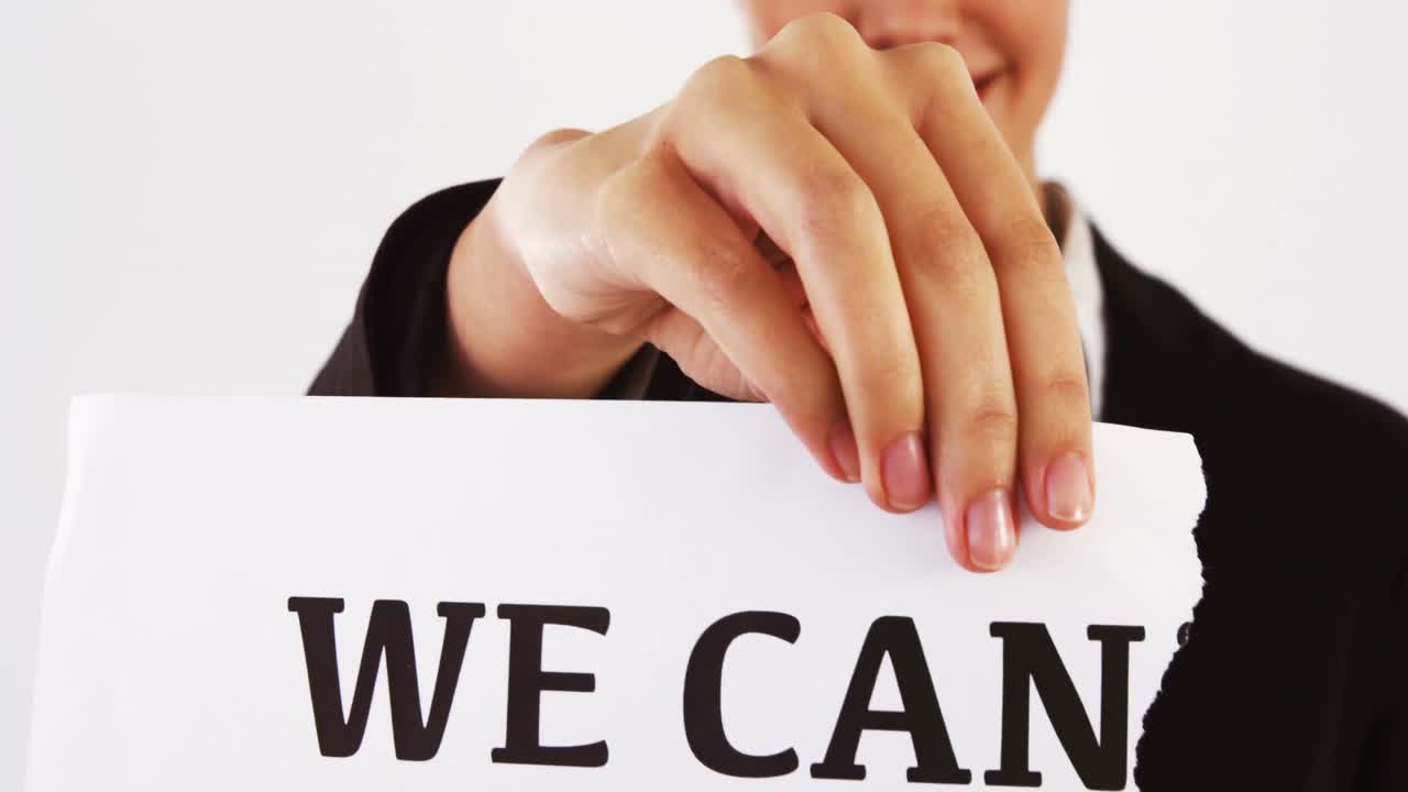 사업가 여자가 우리가 할 수 없다는 표지판을  ⁇ 고 있습니다.