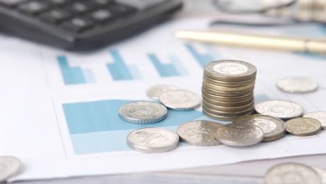 financial documents with stack of coins