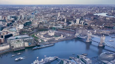 timelapse of tower bridge in london, with traffic and pedestrians moving through the iconic landmark as ferries cross and depart from pier, high angle overview