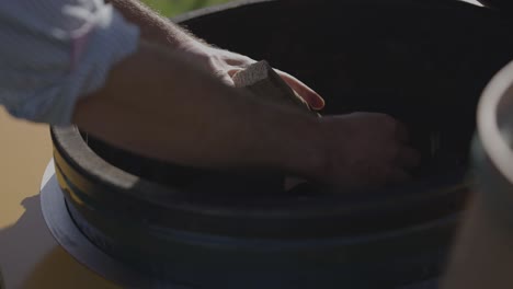 Putting-wood-into-a-outside-BBQ