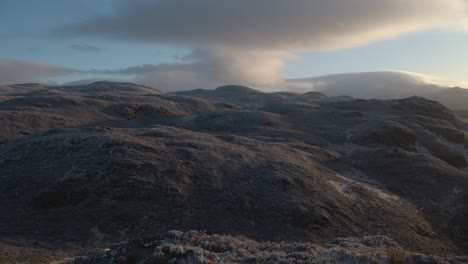 Slow-panning-shot-of-the-snowy-mountain-range-on-view-from-Ben-A'an