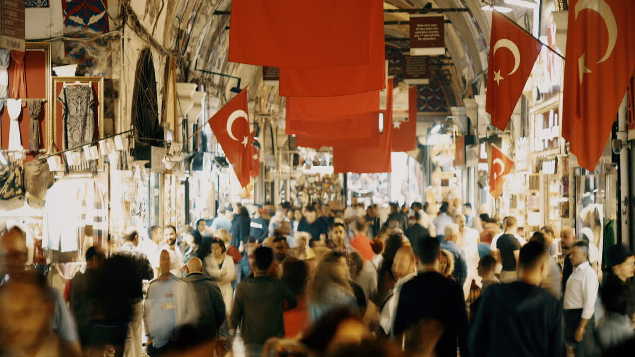 Crowd of travellers and buyers on Grand Bazaar in Istambul are looking at the shops