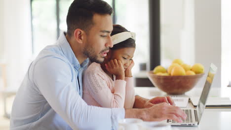 single father typing on laptop