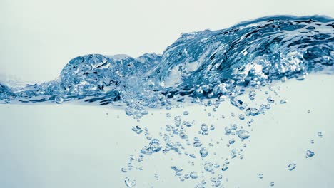 many bubbles in water close up, abstract water wave with bubbles in slow motion