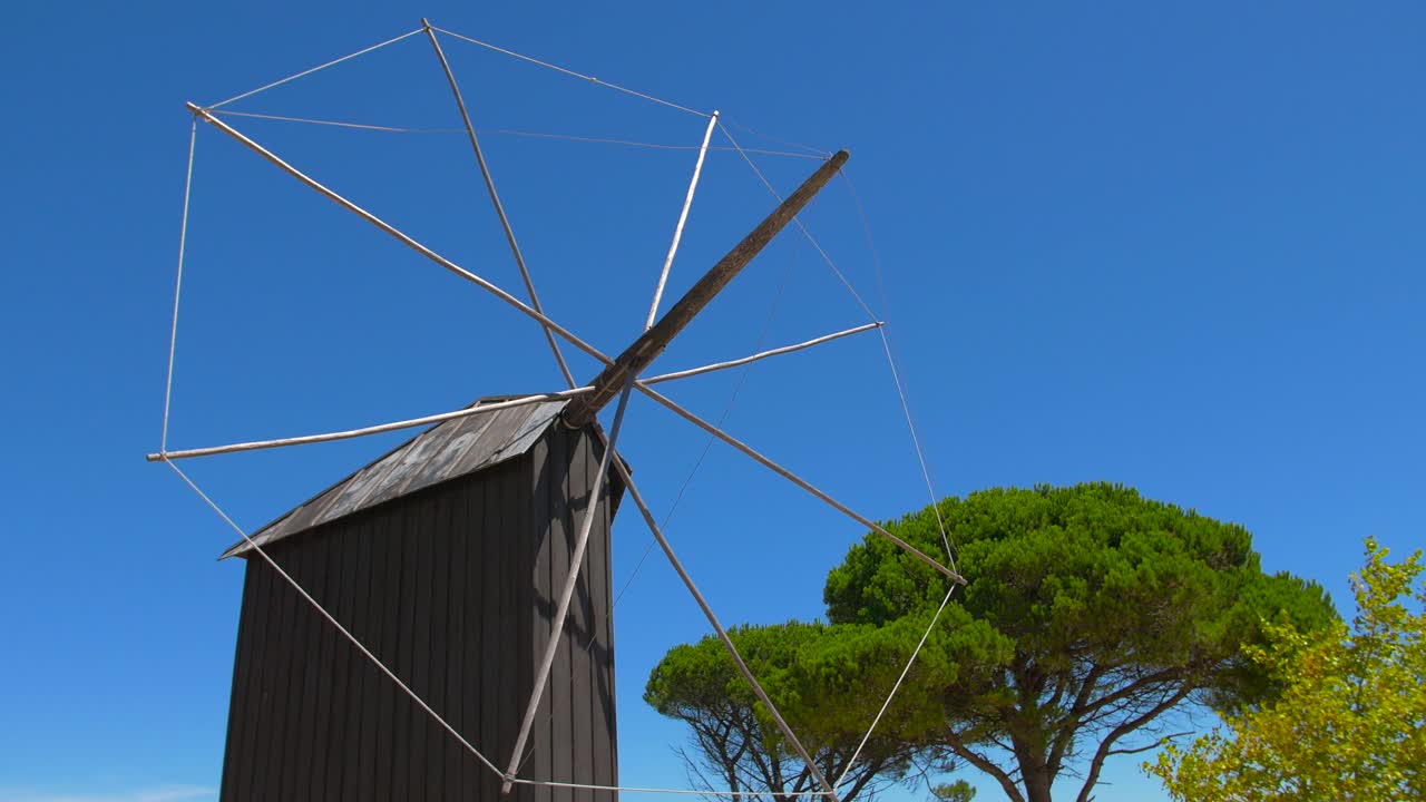Old Wooden Windmill in a Sunny Landscape